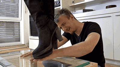 Crushing his hands under my boot soles