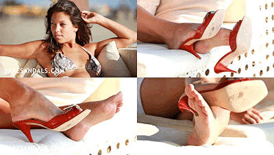 Nina laying down dangling red sandals